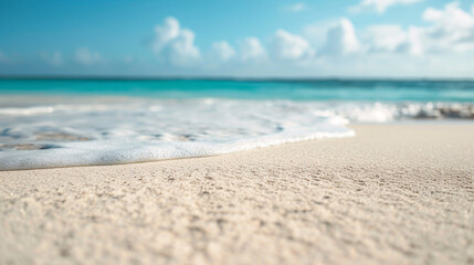 Fototapeta na wymiar White sand at a tropical beach close-up, ocean in the background