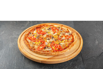 delicious pizza with chicken, mushrooms, cheese, tomatoes and corn on a concrete background
