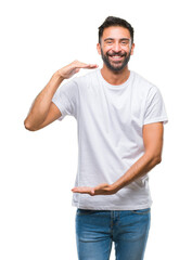 Fototapeta premium Adult hispanic man over isolated background gesturing with hands showing big and large size sign, measure symbol. Smiling looking at the camera. Measuring concept.