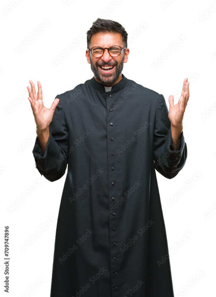 Canvas Prints Adult hispanic catholic priest man over isolated background celebrating mad and crazy for success with arms raised and closed eyes screaming excited. Winner concept