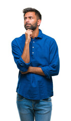 Adult hispanic man over isolated background with hand on chin thinking about question, pensive...