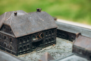 Wedding rings of the bride and groom on the model of the castle