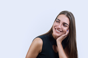 Fototapeta premium Smiling beautiful woman looking to the side, copy space on white background