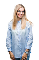 Young beautiful blonde business woman wearing glasses over isolated background looking away to side with smile on face, natural expression. Laughing confident.