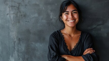 Fototapeta premium Arms folded, lovely girl against a grey wall.