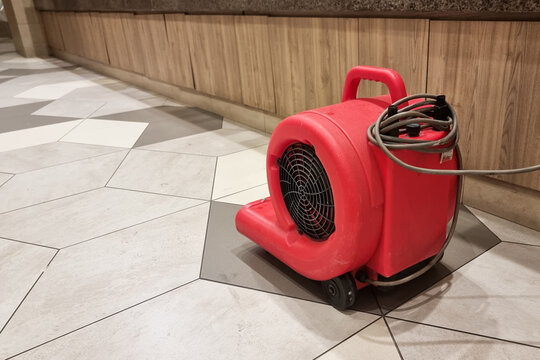 Close-up of portable floor dryer fan used in public washroom and toilet to dry the floor after washing and cleaning