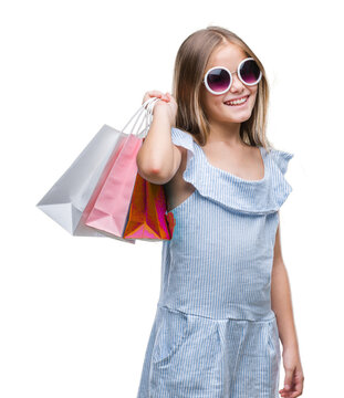 Young beautiful girl holding shopping bags on sales over isolated background with a happy face standing and smiling with a confident smile showing teeth