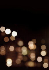Golden blurred bokeh lights on black background.