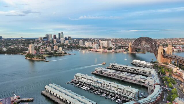 Sydney, Australia: Aerial view of iconic landmark Sydney Harbour Bridge in capital city of Australian state of New South Wales, North Sydney Business District on horizon