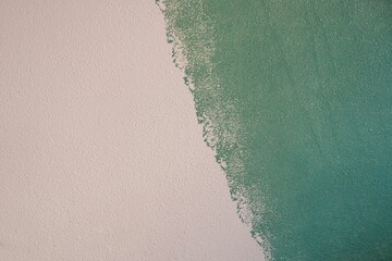 Half white and green color wallpaper with rough surface texture
