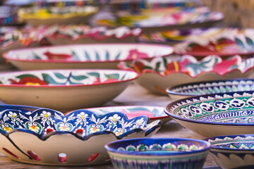 Ceramics with glaze and traditional paintings and patterns of Central Asia, in the ancient city of Khiva in Khorezm - obrazy, fototapety, plakaty