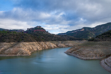 Fototapeta na wymiar View of the Siurana reservoir, Catalonia, almost empty due to the drought, horizontally