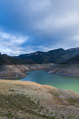 Fototapeta na wymiar View of reservoir almost empty due to drought, Siurana, Spain, Europe, November 21, 2023, vertical