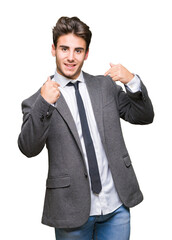 Young business man wearing suit and tie over isolated background looking confident with smile on face, pointing oneself with fingers proud and happy.