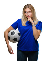 Young caucasian woman holding soccer ball over isolated background serious face thinking about question, very confused idea