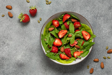 Spring vegetarian salad with fresh strawberries and arugula. View from above