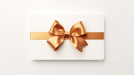 Blank gift card with golden bow isolated on white top view