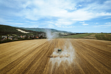Aerial view of a harvester working in a field. Agriculture and cultivation of industrial farms....
