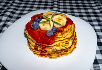 Pancakes with berries and strawberry jam