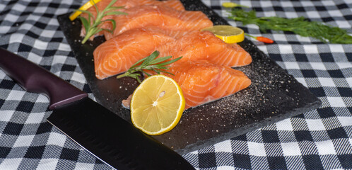 Fresh raw salmon fillet on stone plate