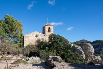 Fototapeta na wymiar View of the Church of Santa Maria in Siurana, Tarragona, with blue sky, horizontal