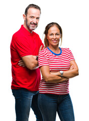 Fototapeta premium Middle age hispanic couple in love over isolated background happy face smiling with crossed arms looking at the camera. Positive person.