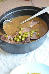 beef filet mignon with sauce and pickled cucumber