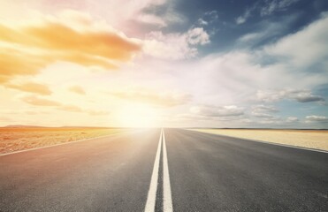 Asphalt highway with beautiful view of sunset and clouds