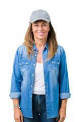 Beautiful middle age woman wearing sport cap over isolated background with a happy and cool smile...