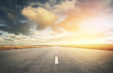 Fototapeta premium Asphalt highway with beautiful view of sunset and clouds