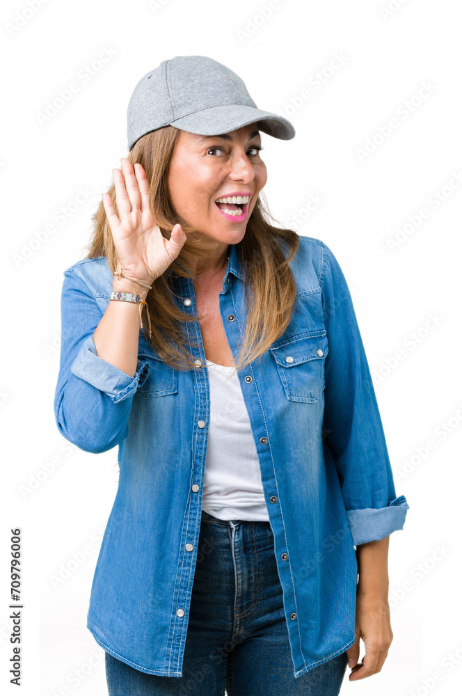 Poster Beautiful middle age woman wearing sport cap over isolated background smiling with hand over ear listening an hearing to rumor or gossip. Deafness concept.