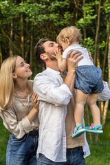 Cute young couple with their baby looking happy