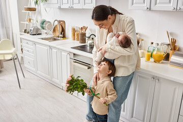 caring joyful family in housewear posing with flower bouquet while on kitchen, modern parenting