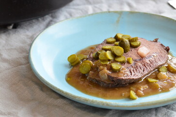 beef filet mignon with sauce and pickled cucumber
