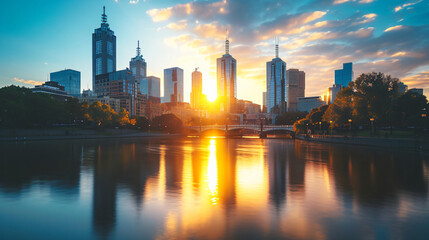 Fototapeta na wymiar Sunset behind a city skyline reflecting in a river creating a stunning urban landscape.