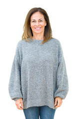 Beautiful middle age woman wearing winter sweater over isolated background with a happy and cool...