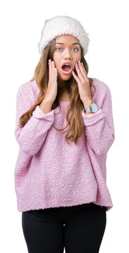 Young beautiful brunette woman wearing sweater and winter hat over isolated background afraid and shocked with surprise expression, fear and excited face.