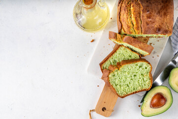 Homemade avocado loaf of bread, keto diet recipe, healthy alternative food idea, on white kitchen...