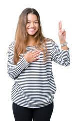Young beautiful brunette woman wearing stripes sweater over isolated background Swearing with hand...