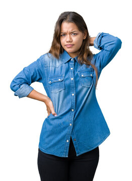 Young beautiful brunette woman wearing blue denim shirt over isolated background Suffering of neck ache injury, touching neck with hand, muscular pain