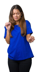 Young beautiful brunette woman wearing blue t-shirt over isolated background disgusted expression, displeased and fearful doing disgust face because aversion reaction. With hands raised. Annoying