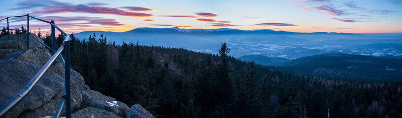 Winter panorama of the Karkonosze Mountains from the Skalnik peak in the Rudawy Janowickie mountains - sunset over the Śnieżka peak - obrazy, fototapety, plakaty