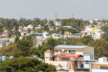 A cityscape of rooftops of low rise houses in the town of Hassan.