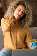 Tired young woman touch stiff neck feeling hurt joint back pain rubbing massaging tensed muscles...