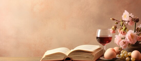Jewish Passover Concept. Still life with wine glass, book and flowers on wooden background.