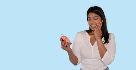 young woman in white shirt with an alarm clock  going to be late