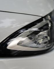 Headlight of a car in great detail with reflections