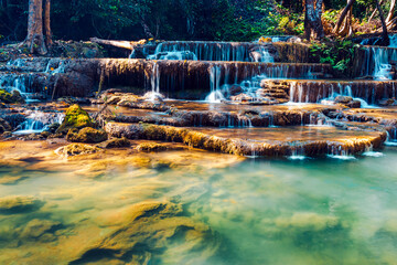 Beautiful of Huai mae khamin waterfall Srinakarin national park at Kanchanaburi thailand. Waterfall clear emerald water on autumn and summer season with rock for holiday relax on green tree in jungle.