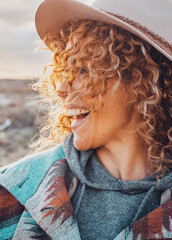 Side portrait of overjoyed and excited cheerful pretty woman with curly blonde hair and hat have...