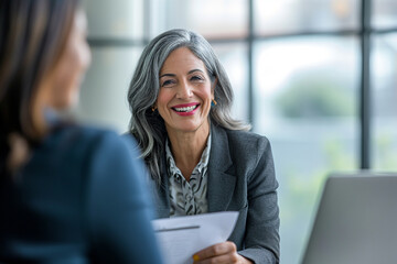 Confident Mature Businesswoman in Corporate Setting Engaging in Professional Consultation, Holding CV with a Pleasant Demeanor, Legal Advisor at Work, Employment Expert Discussing Career Opportunities - obrazy, fototapety, plakaty